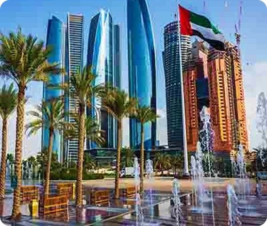 Abu Dhabi towers and fountains with the UAE flag